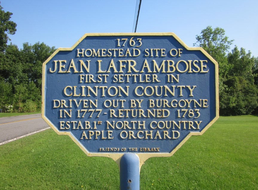Historical panel in northern New York: 1763 - Homestead Site of Jean Laframboise - First settler in Clinton County - Driven out by Burgoyne in 1777 - Returned 1783 - Established 1st North Country apple orchard