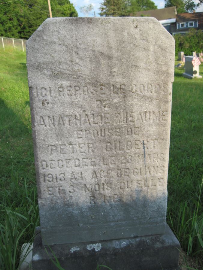 Grave stone that reads: "Ici repose le corps de Anathalie Rheaume, épouse de Peter Gilbert, décédée le 23 mars 1913 à l'âge de 61 ans et 3 mois où elle R.I.P."